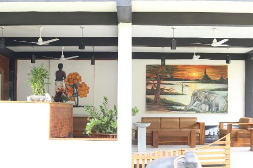 a rendering of a restaurant with a painting on the wall at Eco Hotel Black & White - Anuradhapura in Mihintale