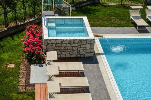 an overhead view of a swimming pool with chairs and flowers at Maso Agritur Santa Lucia in Dro