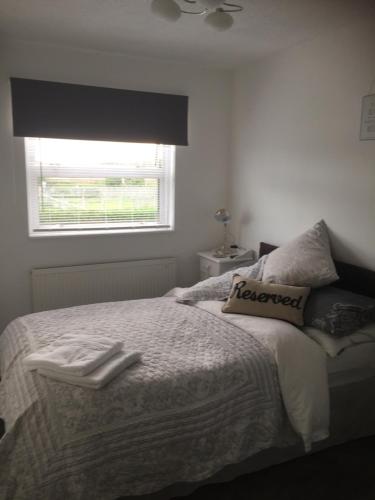 a bedroom with a bed and a window at Southend Airport Bed & Breakfast in Rochford