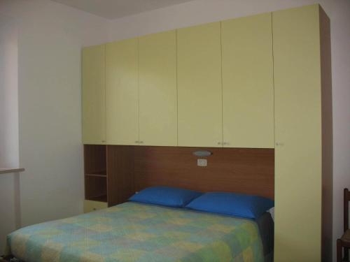 a bedroom with a bed with a cabinet above it at Bed & Breakfast Bompadre in Civitanova Marche