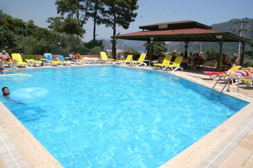 a large swimming pool with chairs and a table at Life Apart in Marmaris
