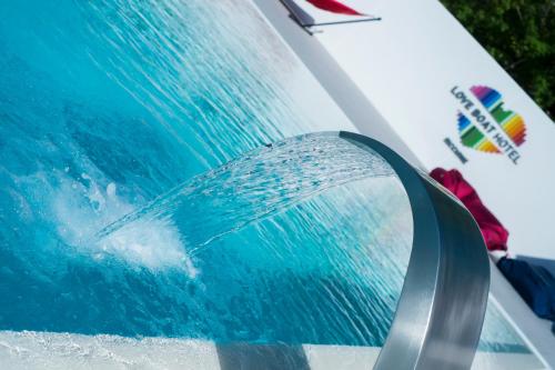 a close up of a water hose on a car at Love Boat Hotel - The Original in Riccione