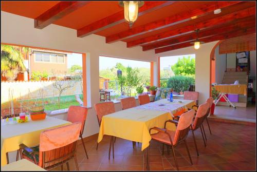 a dining room with a table and chairs at Apartments Nives NB in Savudrija
