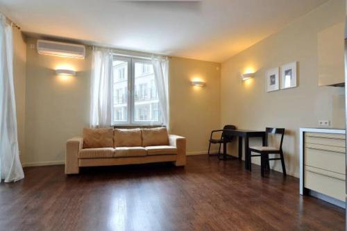 a living room with a couch and a table at Żoliborz Apartamenty in Warsaw