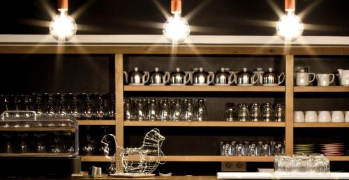 a bar with glasses on a shelf with a duck on it at Rossi Hôtel in Sartène