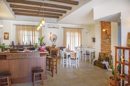 a living room with a bar and a dining room at Archontiko in Ammouliani