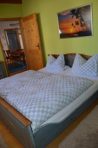 a bedroom with a large bed with white pillows at Schuler-Petschler in Obereisenheim