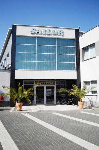a building with a sign on the side of it at Willa Sailor Pabianice in Pabianice