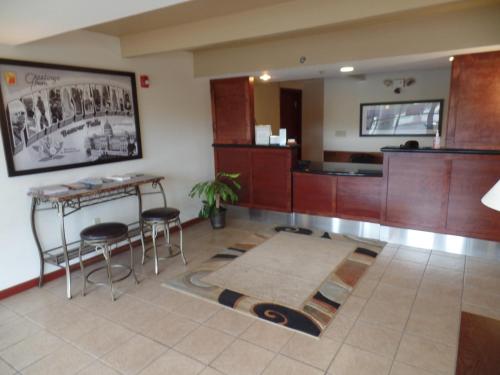 a lobby with a table and stools in a room at Super 8 by Wyndham Beaver Falls in Beaver Falls