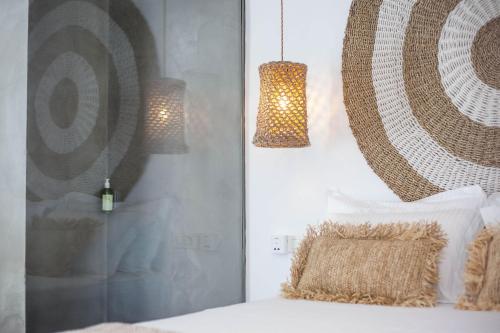 a bedroom with two pendant lights and a bed at Malibu Boutique Studios & Bungalows in Faliraki