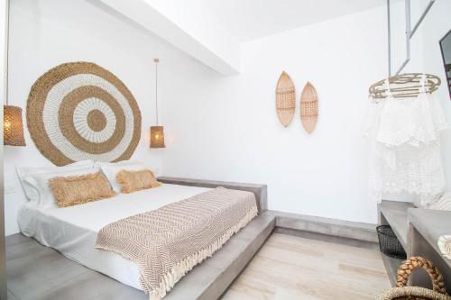 a bedroom with a bed with a target on the wall at Malibu Boutique Studios & Bungalows in Faliraki