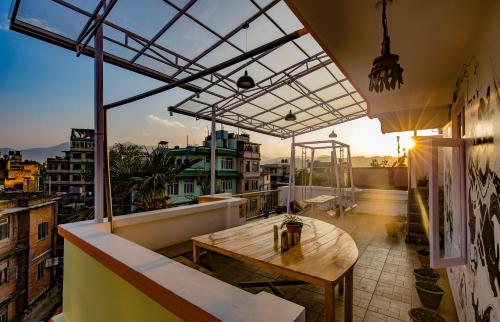 a patio area with a table and chairs at Zostel Kathmandu in Kathmandu