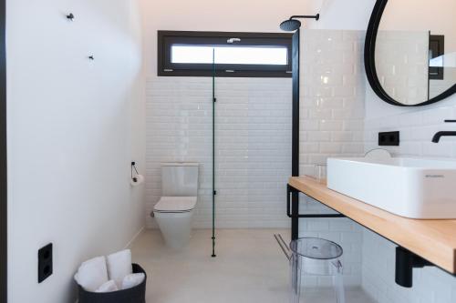 a bathroom with a sink and a toilet at Sodium Boutique Hotel in Ciutadella