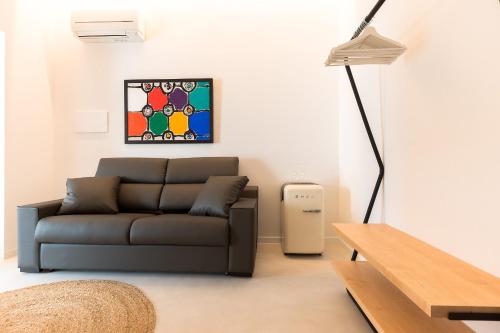 a living room with a couch and a table at Sodium Boutique Hotel in Ciutadella
