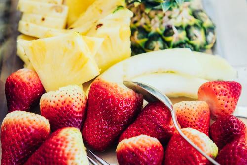 a pile of strawberries and bananas and a spoon at Gästehaus Klinglhuber in Krems an der Donau