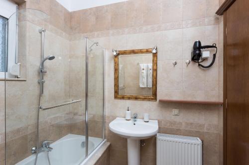 a bathroom with a sink and a glass shower at Villa Dimitra Gennadi in Gennadi