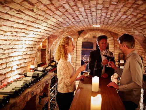 a group of people standing at a table with wine glasses at Hotel Auriga in Lech am Arlberg