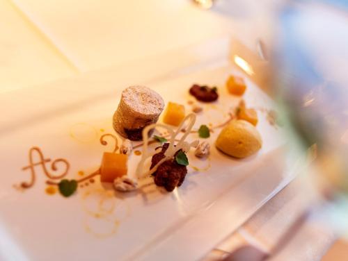 a white plate with food on a table at Hotel Auriga in Lech am Arlberg