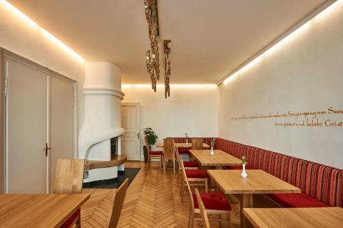 a dining room with wooden tables and chairs at Hotel Garni Bodensee in Bregenz
