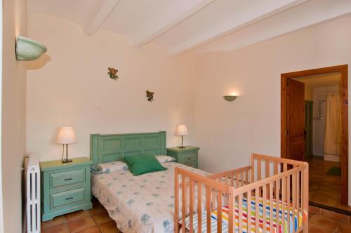 a bedroom with a green bed and two night stands at Es Rafal Roig (Verd) in Manacor