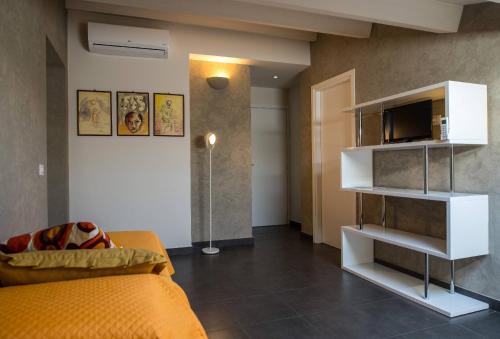 a living room with a couch and a television at B&B Casa Liuzza in Santa Teresa di Riva