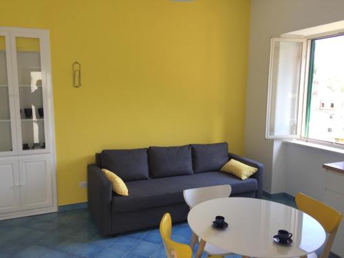 a living room with a couch and a table at Casa Sole in Minori