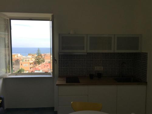 a kitchen with a view of the ocean from a window at Casa Sole in Minori
