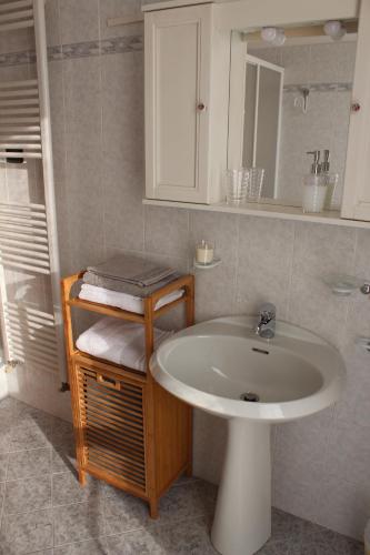 a bathroom with a sink and a mirror at Casa "La Valle dei Segni" in Piancogno