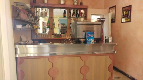 a kitchen with a counter with a coffee maker at Hotel Capitol in Rimini