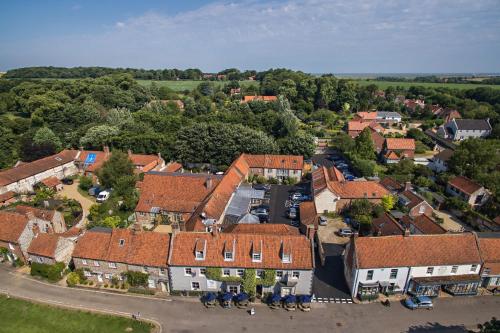 an aerial view of a small village with houses at The Hoste and The Vine House Hotels in Burnham Market