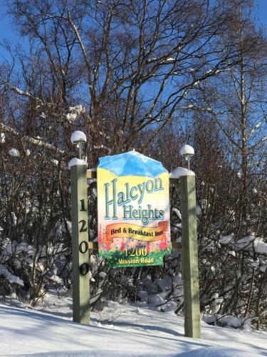 a sign for a library of heights in the snow at Halcyon Heights B&B/Inn in Homer