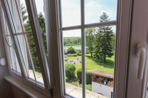 a window view of a lake from a house at Domaine du Port Sainte Marie in Maizières-lès-Vic