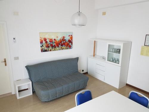 a living room with a couch and a painting on the wall at Hotel Residence Adriana in Cesenatico