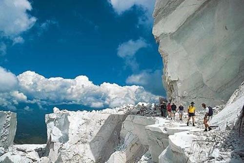 a group of people standing on top of a snowy mountain at LIGURIA home in Ameglia