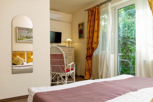 Postel nebo postele na pokoji v ubytování Albergo Giardino