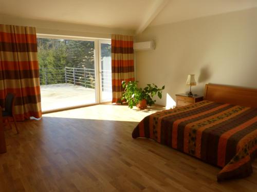 a bedroom with a bed and a sliding glass door at Viva Apartment - Pirita in Tallinn