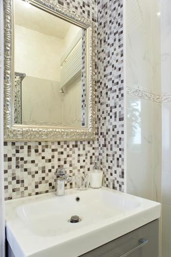 a bathroom with a white sink and a mirror at Residenza Elisabetta in Verona