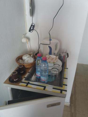 a kitchen with two bottles of water on a counter at Sol e Mar Sea Side View Guesthouse in Perama