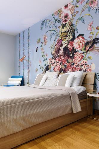 a bedroom with a large bed with a floral wallpaper at Lora Luxury House, near the lake with air conditioners in Como