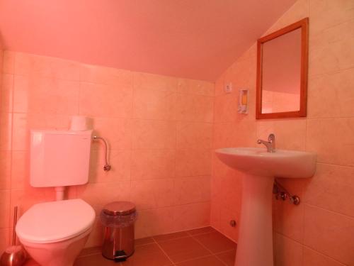 a bathroom with a toilet and a sink at Hotel Restoran Antika in Strumica