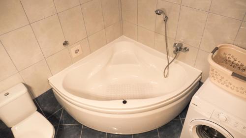 a shower in a bathroom with a toilet and a sink at Enjoy in Omiš