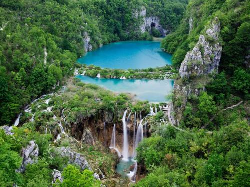 a waterfall in a canyon with blue water at Rooms Marina in Korenica