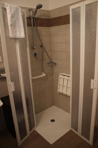 a shower with a glass door in a bathroom at Albergo Ristorante Bismantova in Castelnovo neʼ Monti