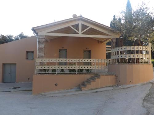 a house with a fence and stairs in front of it at Apothiki House in Kato Korakiana