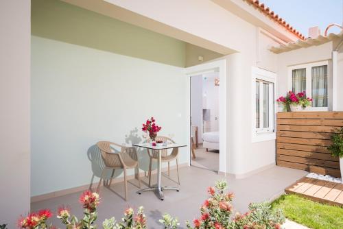 a patio with a table and chairs in a house at Hermes Beach Front in Stalos