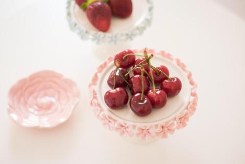 a cake with cherries on top of it on a table at Hermes Beach Front in Stalos