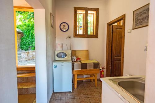 a kitchen with a white refrigerator and a sink at Hostel Pashov in Veliko Tŭrnovo