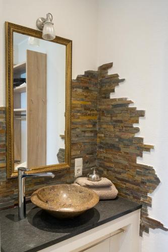 a bathroom with a sink and a mirror at Feriendomizil "Alte Post" I in Pronsfeld