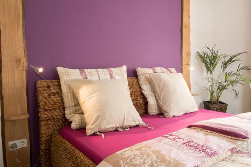 a bedroom with purple walls and a bed with pillows at Feriendomizil "Alte Post" I in Pronsfeld