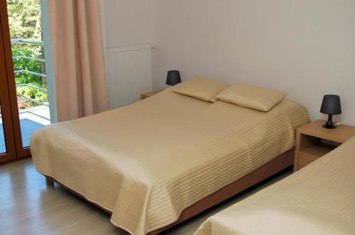 a bedroom with a bed and a window at Villa Camp in Jurata